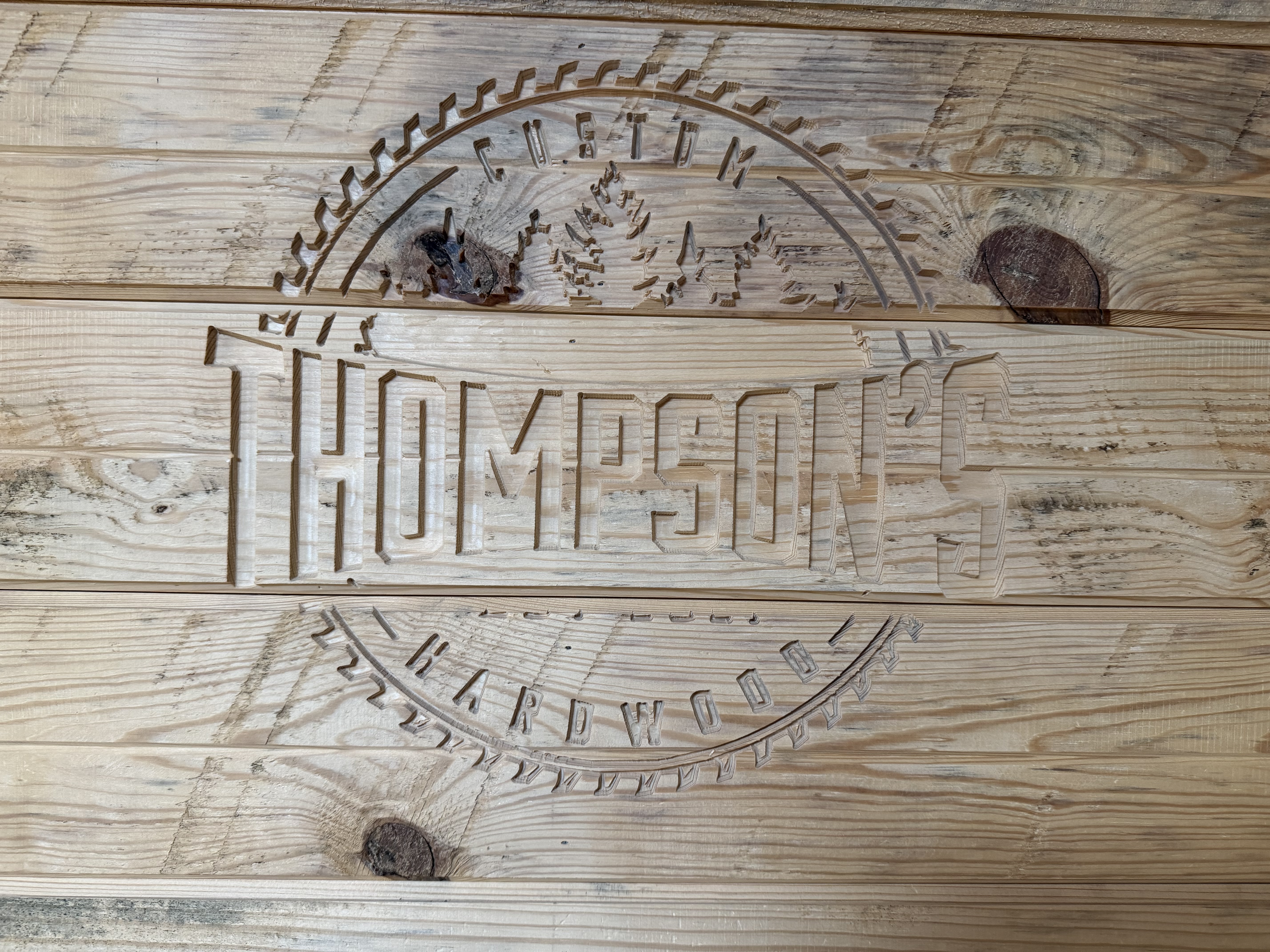 Thompson's Custom Hardwood engraved logo